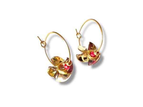 Boucles d’oreilles créoles artisanales en forme d’hélice avec perle rose, en laiton doré.